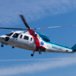 A medevac helicopter on on approach to land at an accident site.